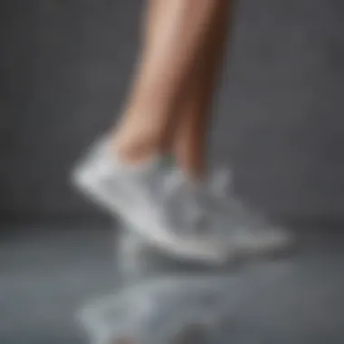 Elegant silver sparkly tennis shoes on a reflective surface