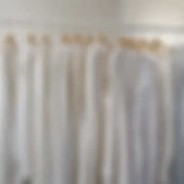 Variety of fabric choices for white long tops displayed on hangers